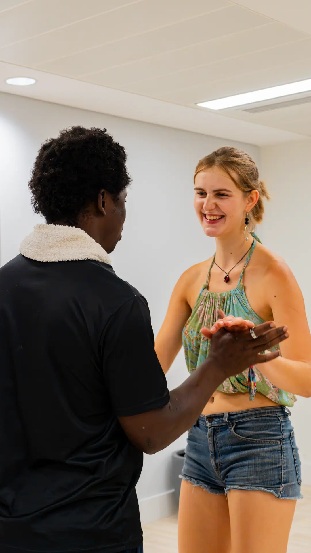 A lead and follow laughing together during class